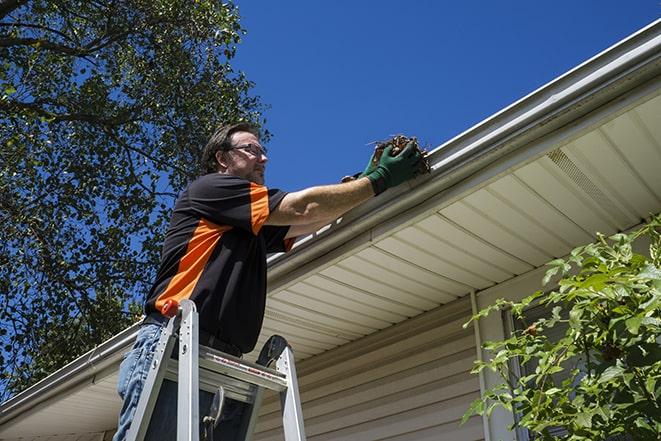 handyman repairing a leaky gutter in Burlington WA